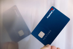 Capital One Venture Rewards credit card held in a hand