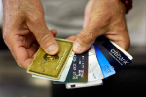Hands comparing a selection of credit cards